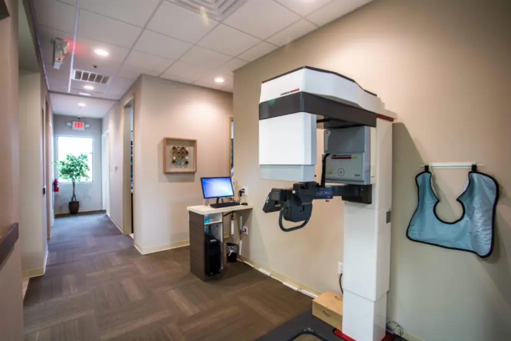 A room with a computer and a dental equipment